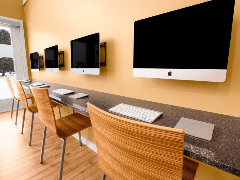 This image shows the community amenities, particularly the apple computer bar featuring a flat-screen computer set and a window to overlook the TGM Springbrook. The bar was ideal for business and leisure experience.