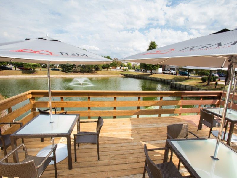 This image shows the community patio or balcony of TGM Springbrook Apartments featuring the scenic view of the pond. This area was perfect for leisure recreation and relaxing moment.