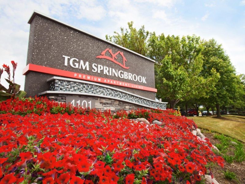 This image shows the TGM Springbrook Apartments monument in Aurora, IL.