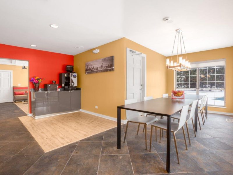 This image shows the community amenities featuring the café lounge showcasing the long table seats while enjoying the coffee treat.